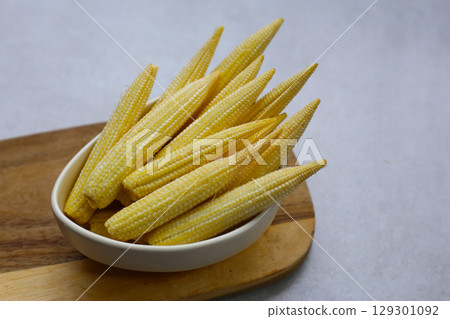 Raw, fresh yellow baby corn Raw, fresh yellow baby corn 129301092