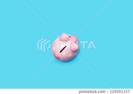 Pinggy bank on blue background. 129301157
