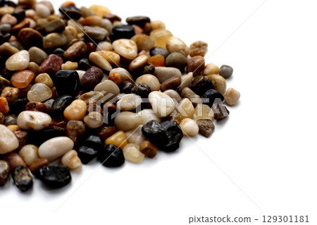 Small colorful pebbles on a white background. Small colorful pebbles on a white background. 129301181