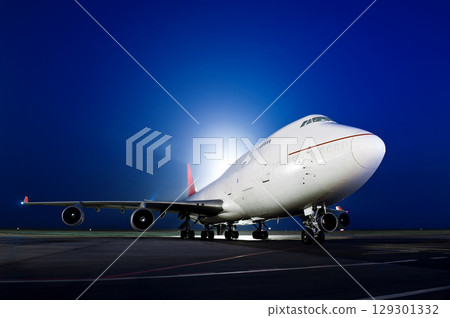 The plane stands at the airport at night 129301332