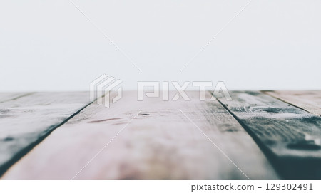 Wooden surface with soft lighting creating a warm atmosphere inside a cozy space 129302491