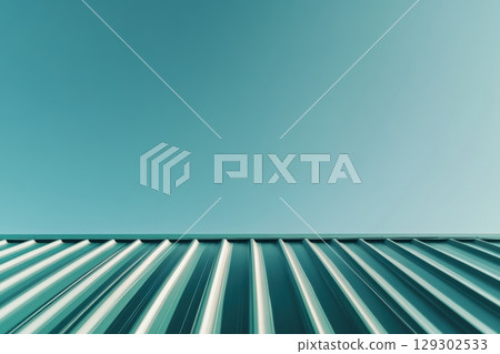 Striking turquoise sky contrasting with metallic roof lines during midday 129302533