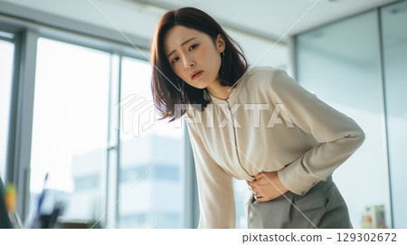 Japanese woman falls ill at the office 129302672