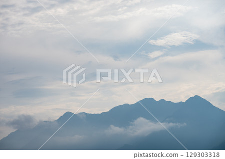 Majestic mountains rise above the clouds in DuJiangYan 129303318