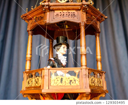 Classical illustration of Czech-dressed marionettes standing on an elaborate wooden balcony 129303495