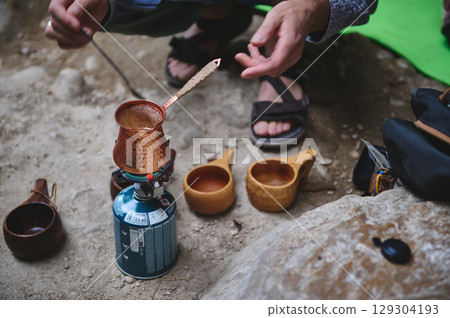 Outdoor Coffee Preparation Using Traditional Copper Pot and Camping Gear Outdoor Coffee Preparation Using Traditional Copper Pot and Camping Gear 129304193