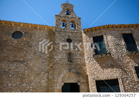 Historic Stone Church Bell Tower Under Clear Blue Sky 129304257