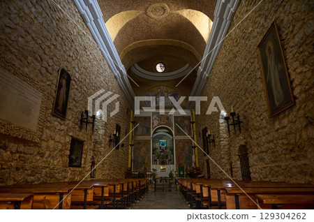 Rustic Interior of a Medieval Stone Church with Vaulted Ceilings 129304262