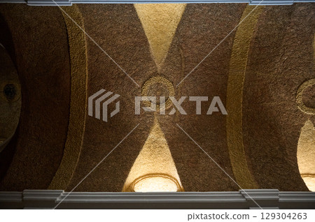 Elegant Ceiling with Decorative Patterns and Subtle Gold Highlights Elegant Ceiling with Decorative Patterns and Subtle Gold Highlights 129304263