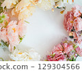 Colorful floral arrangement forming a circular frame on white background 129304566