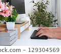 Modern workspace with hands typing on keyboard 129304569