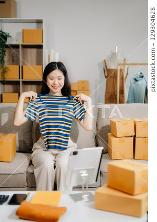 Fashion blogger concept, Young Asian women selling clothes on video streaming.Startup small business SME 129304628
