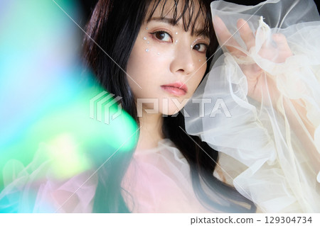 Luxury beauty fashion portrait of young woman in dress on dark background 129304734