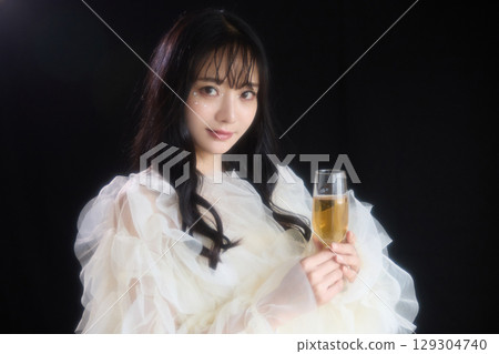 Luxury beauty fashion portrait of young woman in dress on dark background 129304740