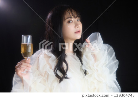 Luxury beauty fashion portrait of young woman in dress on dark background 129304743