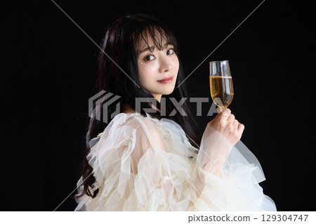 Luxury beauty fashion portrait of young woman in dress on dark background Luxury beauty fashion portrait of young woman in dress on dark background 129304747