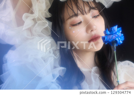 Luxury beauty fashion portrait of young woman in dress on dark background Luxury beauty fashion portrait of young woman in dress on dark background 129304774