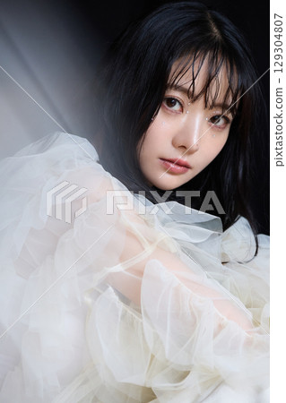 Luxury beauty fashion portrait of young woman in dress on dark background 129304807