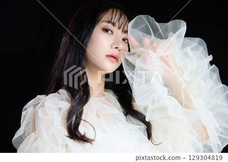 Luxury beauty fashion portrait of young woman in dress on dark background 129304819