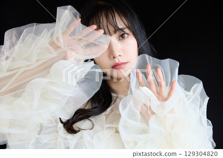 Luxury beauty fashion portrait of young woman in dress on dark background 129304820