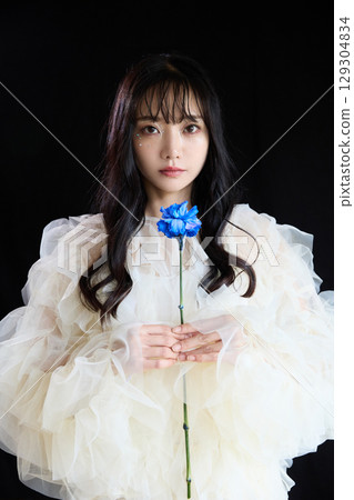 Luxury beauty fashion portrait of young woman in dress on dark background 129304834