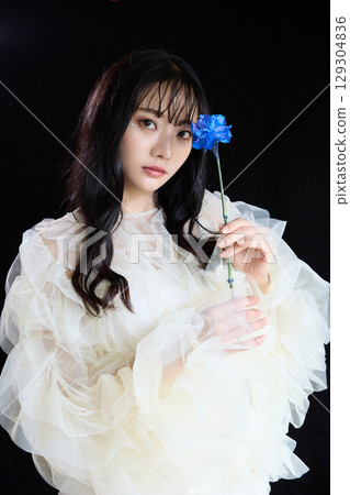 Luxury beauty fashion portrait of young woman in dress on dark background 129304836