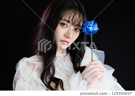 Luxury beauty fashion portrait of young woman in dress on dark background 129304837