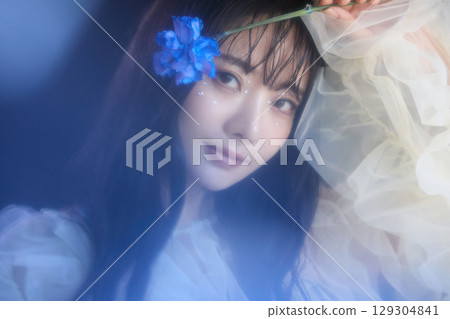 Luxury beauty fashion portrait of young woman in dress on dark background 129304841