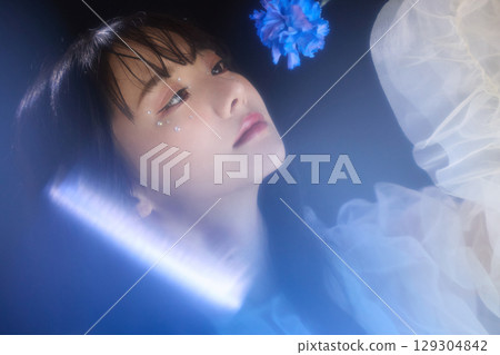 Luxury beauty fashion portrait of young woman in dress on dark background 129304842