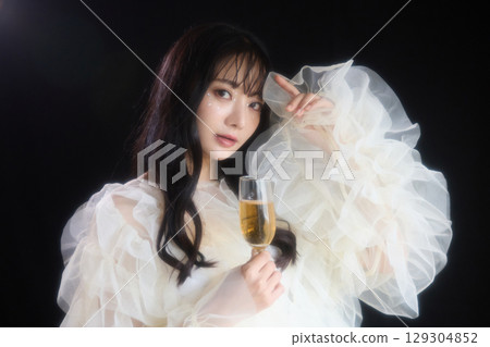 Luxury beauty fashion portrait of young woman in dress on dark background 129304852