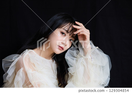 Luxury beauty fashion portrait of young woman in dress on dark background 129304854