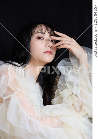 Luxury beauty fashion portrait of young woman in dress on dark background Luxury beauty fashion portrait of young woman in dress on dark background 129304857