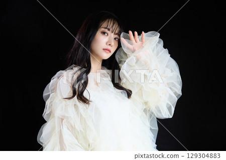Luxury beauty fashion portrait of young woman in dress on dark background 129304883