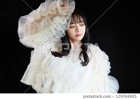 Luxury beauty fashion portrait of young woman in dress on dark background 129304885