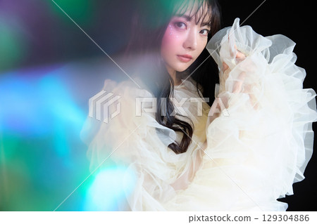 Luxury beauty fashion portrait of young woman in dress on dark background Luxury beauty fashion portrait of young woman in dress on dark background 129304886
