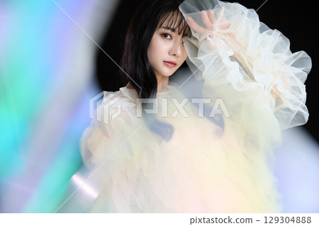 Luxury beauty fashion portrait of young woman in dress on dark background 129304888