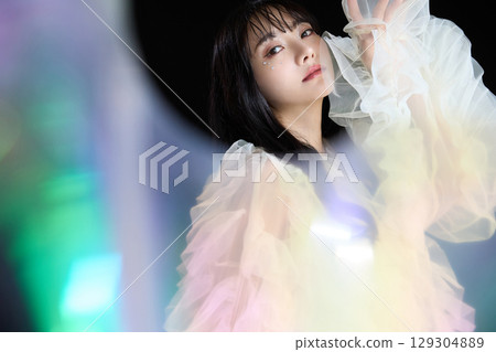 Luxury beauty fashion portrait of young woman in dress on dark background 129304889