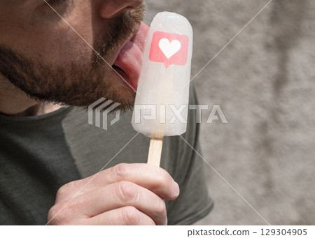 Man licks ice lolly with likes icon 129304905