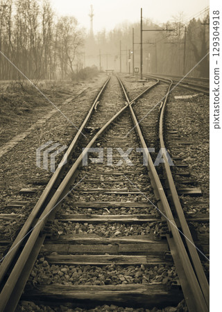 Sepia Toned Railway Tracks Splitting in Misty Landscape Sepia Toned Railway Tracks Splitting in Misty Landscape 129304918