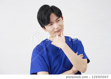 Doctor, nurse, dentist, caregiver, male, worried, white background Doctor, nurse, dentist, caregiver, male, worried, white background 129305047
