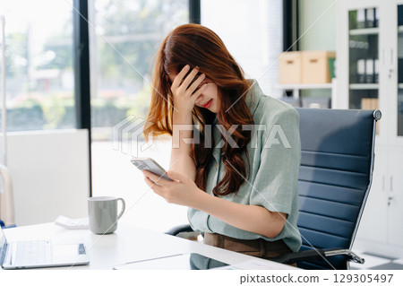 Asian business woman is stressed, bored, and overthinking from working 129305497