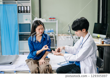 Doctor examining patient with symptoms in a clinic. Medical consultation and healthcare interaction. 129305897