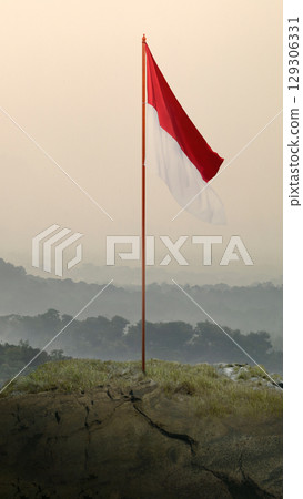 Closeup view of the Indonesian national flag waving against a sky background. Celebrate Indonesia Independence Day. Concept of Kemerdekaan Indonesia Closeup view of the Indonesian national flag waving against a sky background. Celebrate Indonesia Independence Day. Concept of Kemerdekaan Indonesia 129306331