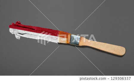 Closeup view of the red and white colors of the Indonesian national flag with a black wall background. Celebrate Indonesia Independence Day. Concept of Kemerdekaan Indonesia 129306337