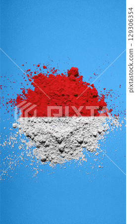 Closeup view of the red and white colors of the Indonesian national flag with a blue wall background. Celebrate Indonesia Independence Day. Concept of Kemerdekaan Indonesia Closeup view of the red and white colors of the Indonesian national flag with a blue wall background. Celebrate Indonesia Independence Day. Concept of Kemerdekaan Indonesia 129306354