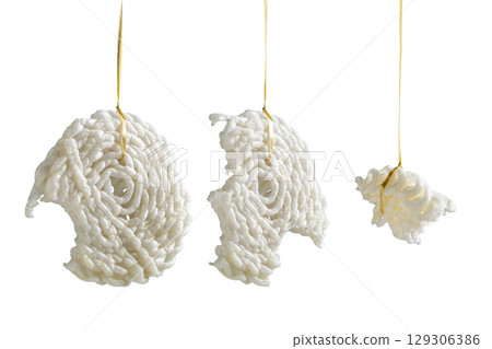 Set of kerupuk crackers hanging on the rope for games to celebrate Indonesia Independence Day isolated over a white background. Concept of Kemerdekaan Indonesia Set of kerupuk crackers hanging on the rope for games to celebrate Indonesia Independence Day isolated over a white background. Concept of Kemerdekaan Indonesia 129306386