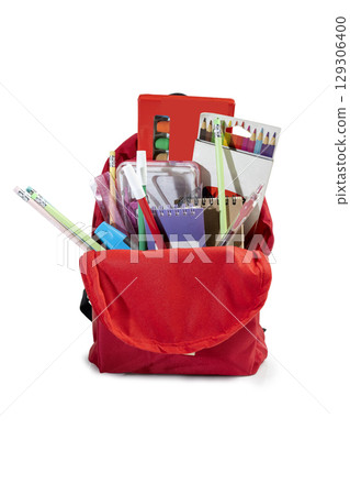 The backpack opens with the arrangement of school supplies isolated over a white background. Copy space. Concept of Back to School The backpack opens with the arrangement of school supplies isolated over a white background. Copy space. Concept of Back to School 129306400