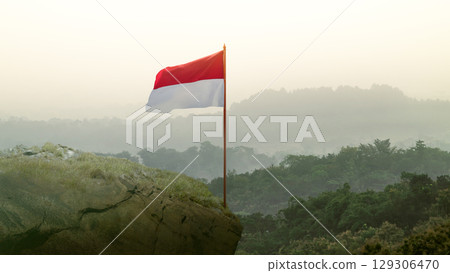 Closeup view of the Indonesian national flag waving against a sky background. Celebrate Indonesia Independence Day. Concept of Kemerdekaan Indonesia 129306470