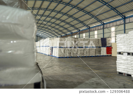 Stacked pallets of goods sacks in a large warehouse. Storage, inventory, industry, and logistics Stacked pallets of goods sacks in a large warehouse. Storage, inventory, industry, and logistics 129306488
