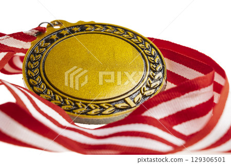 Closeup view of the golden award medal suspended from a red and white striped ribbon isolated over a white background. Copy space. Symbol of achievement, recognition, or competition Closeup view of the golden award medal suspended from a red and white striped ribbon isolated over a white background. Copy space. Symbol of achievement, recognition, or competition 129306501